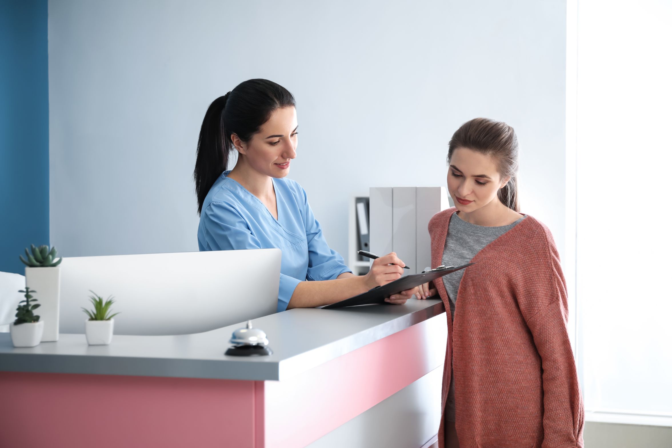 Medical office administrator is helping a patient