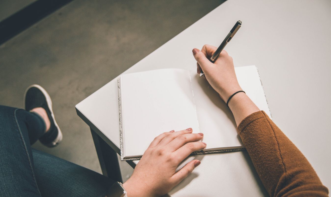 A close up of someone writing on paper