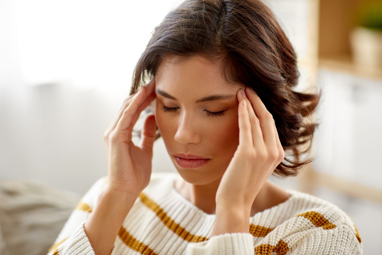 A women is rubbing her temples out of stress