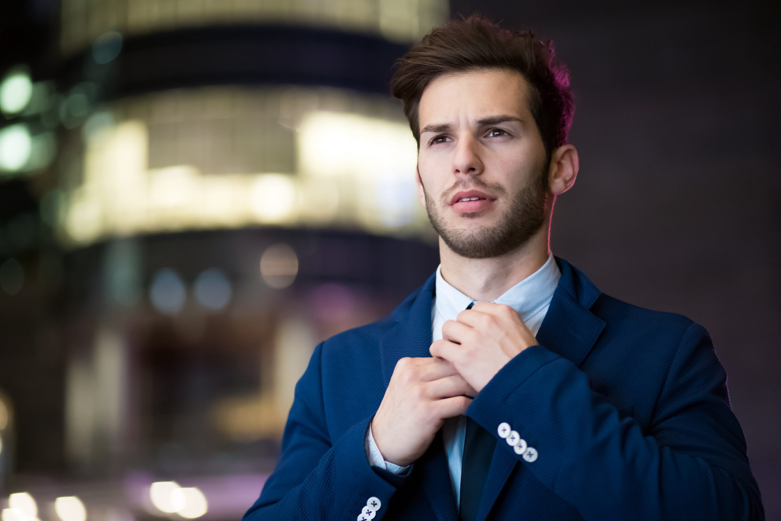 A professional business man is adjusting his tie